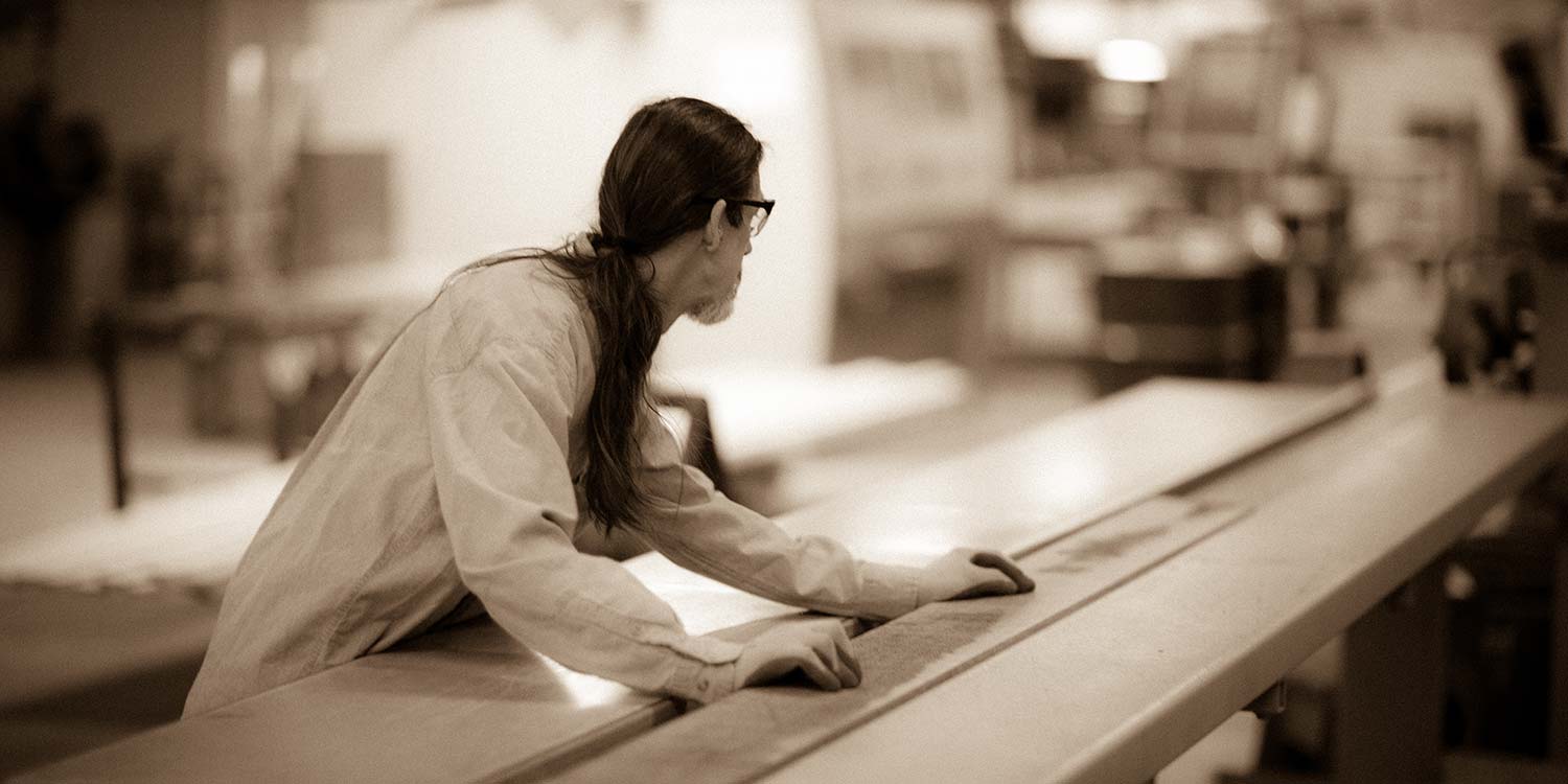 An image of a worker at Kstair working with the lumber for their custom millwork