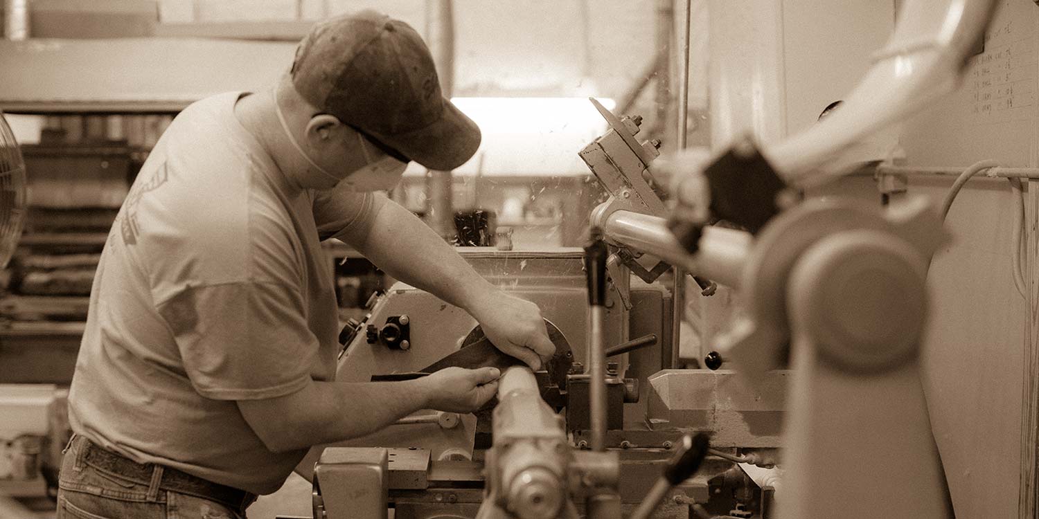 An image of a Kstair worker trimming up a piece of wood