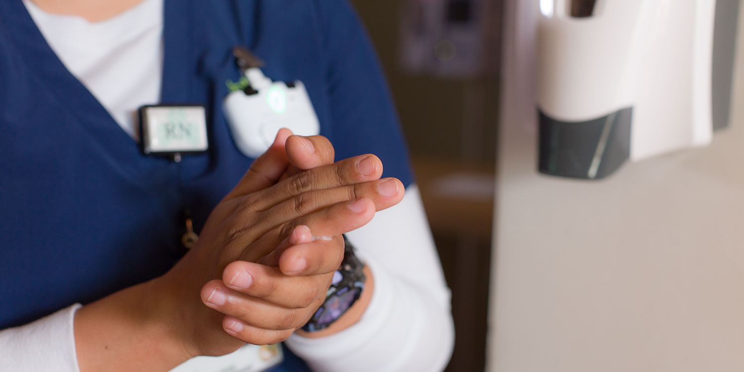 An image of a nurse cleaning her hands with Symmetry hand soap