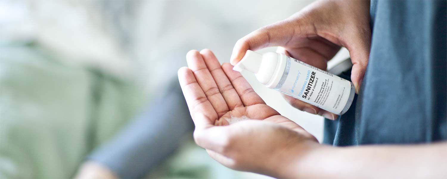 A person using Symmetry Foaming Hand Sanitizer